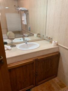 a bathroom with a sink and a mirror at Katarino Mountain House in Razlog