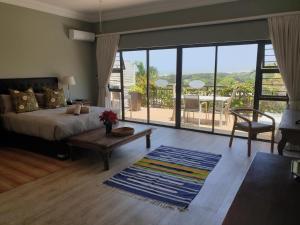 a bedroom with a bed and a large window at Fairway Guest House in Durban