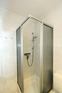 a shower with a glass door in a bathroom at Strandkrabbe in Hörnum