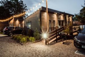 a tiny house with a car parked in front of it at Black Bull Retreat, Barmston with Private Hot Tubs in Great Driffield