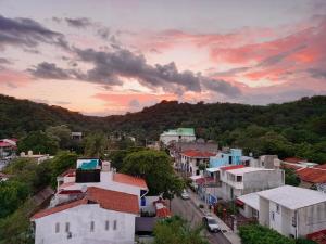a view of a town with a sunset at Hotel Diamante in Santa Cruz Huatulco