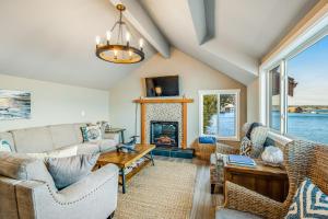 a living room with a couch and a fireplace at Heron House on the Cove in Coupeville