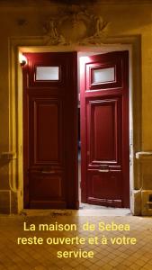 una puerta roja con las palabras "la maison do sederre waederre" en La Maison de Sebea, en Burdeos