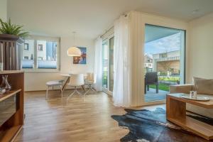 a living room with a large sliding glass door at Sunny Appartment in Bregenz