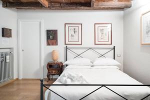 En eller flere senge i et værelse på Fossalta Home, in the heart of the Historical Center