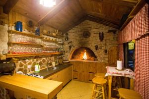 a kitchen with a stove and a brick oven at Kuća za odmor Gloria in Travnik
