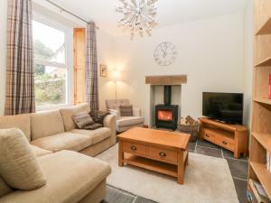 a living room with a couch and a fireplace at Holcombe House in Torquay