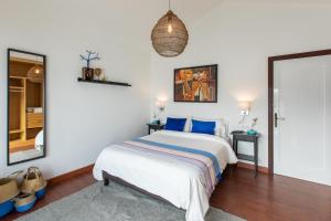a bedroom with a bed and a mirror at Villa Atlantis I in La Asomada +36 photos