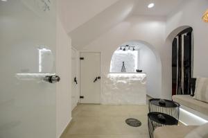 a living room with a white door and a window at Saint George Hotel in Naxos Chora