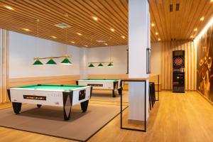 two billiards tables in a room with lights at L'Azure Hotel 4* Sup in Lloret de Mar