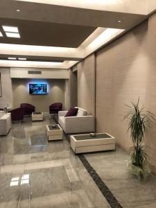 a living room with a couch and a tv at Hotel Olimpia in Imola +29 photos
