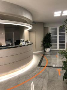 an office lobby with an orange line on the floor at Hotel Olimpia in Imola