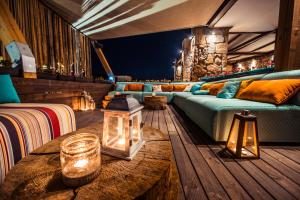 a living room with a couch and a table at Keros Blue - Luxury in Wilderness in Kalliópi