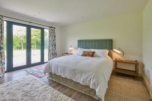 a bedroom with a bed and a large window at The Cabin in Haverfordwest