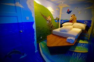 a room with a bed with a painting on the wall at Rose Titanic Belfast romantic world in Belfast