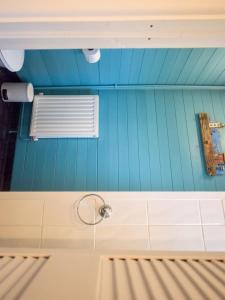 a kitchen with blue walls and a window and a sink at Mount Pleasant Brixham in Brixham