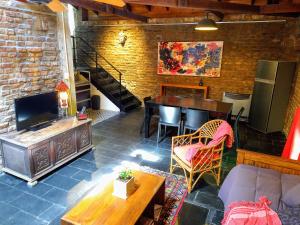 a living room with a television and a table and chairs at Casa Palacio, Arte e Historia in Buenos Aires