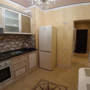 a kitchen with a white refrigerator in a room at 36 жемчужина. Аркадия in Odesa