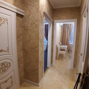 a hallway with a door and a room with a table at 36 жемчужина. Аркадия in Odesa