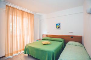 A bed or beds in a room at Residence Il Monello Még 30 kép