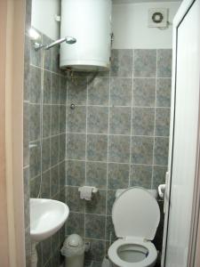a small bathroom with a toilet and a sink at Guesthouse Tzar Asen in Sofia
