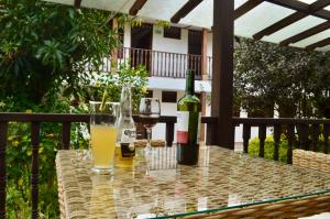 two bottles of wine and glasses on a table at Hotel Casona del Virrey in Moniquirá