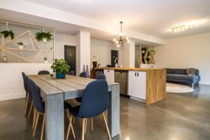 a dining room and kitchen with a wooden table and chairs at Arrows Edge Lodge in Revelstoke