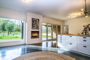 a kitchen with a fireplace and a large window at Arrows Edge Lodge in Revelstoke