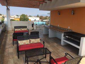 a group of chairs and tables on a patio at Hospedaje Tlaquepaque in Guadalajara