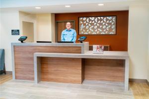 a man standing at a reception desk at Candlewood Suites - Las Vegas - E Tropicana, an IHG Hotel in Las Vegas
