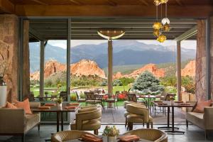 a dining room filled with tables and chairs at Garden of the Gods Club & Resort in Colorado Springs