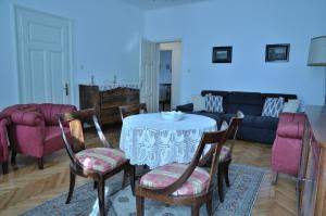 a living room with a table with chairs and a couch at Paril in Crikvenica