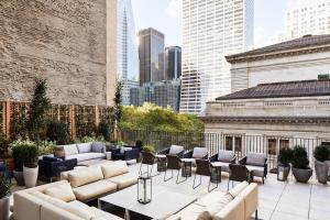 a rooftop patio with couches and chairs on a building at Park Terrace Hotel in New York