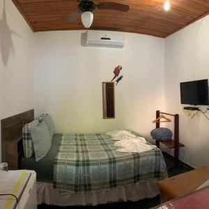 a bedroom with a bed with a bird on the wall at Pousada Céu Azul in Sao Jorge