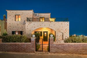 a brick house with an archway in front of it at Neriides Villas in Hersonissos