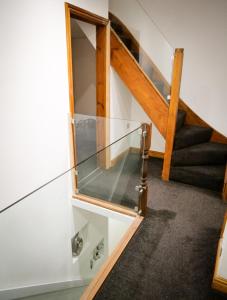 a glass staircase in a room with a stair case at The Stone House in Nottingham