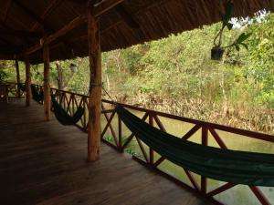 a hammock hanging from a roof on a porch at Phuong Thao Homestay in Vĩnh Long