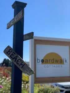 a street sign on a pole in front of a building at Boardwalk Cottages in Long Beach