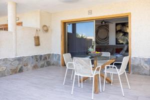 a patio with a table and chairs on it at GIGANTES Oasis Deluxe by Sunkeyrents in Santiago del Teide