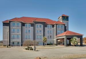 a large building with a clock tower on top of it at La Quinta by Wyndham Lindale in Lindale