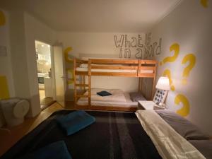 a bedroom with two bunk beds with question marks on the wall at The Bookstore Family Apartment in Hellissandur