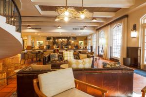 a lobby with couches and tables in a building at Casa De Palmas, Trademark Collection by Wyndham in McAllen