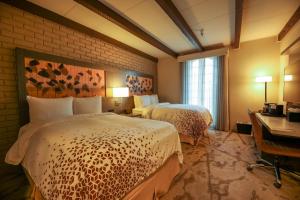 a hotel room with two beds and a window at Casa De Palmas, Trademark Collection by Wyndham in McAllen