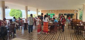 a group of people standing around in a restaurant at สังขละการ์เด้นโฮม in Sangkhla Buri