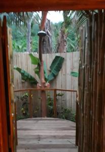 a wooden gate with a bird perched on a tree at Oneta Resort in Ono Island
