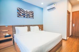 Postel nebo postele na pokoji v ubytování Grand Lee Hotel
