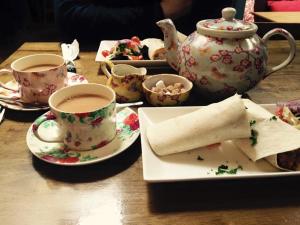 a table with cups of tea and a plate with a burrito at No 6 Glynsk Cottage in Galway