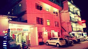 a white car parked in front of a building at Red Star Holidays in Munnar