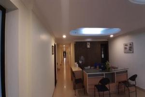 a room with a hallway with a table and chairs at MADAPARAMBIL RESIDENCY in Alwaye