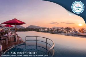 a beach scene with a view of the ocean at The Charm Resort Phuket - SHA Certified in Patong Beach